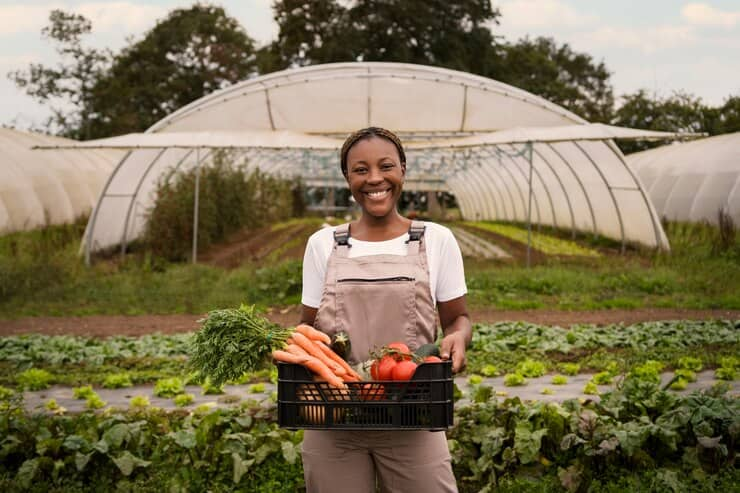 Smiley Woman Holding Box with Vegetables